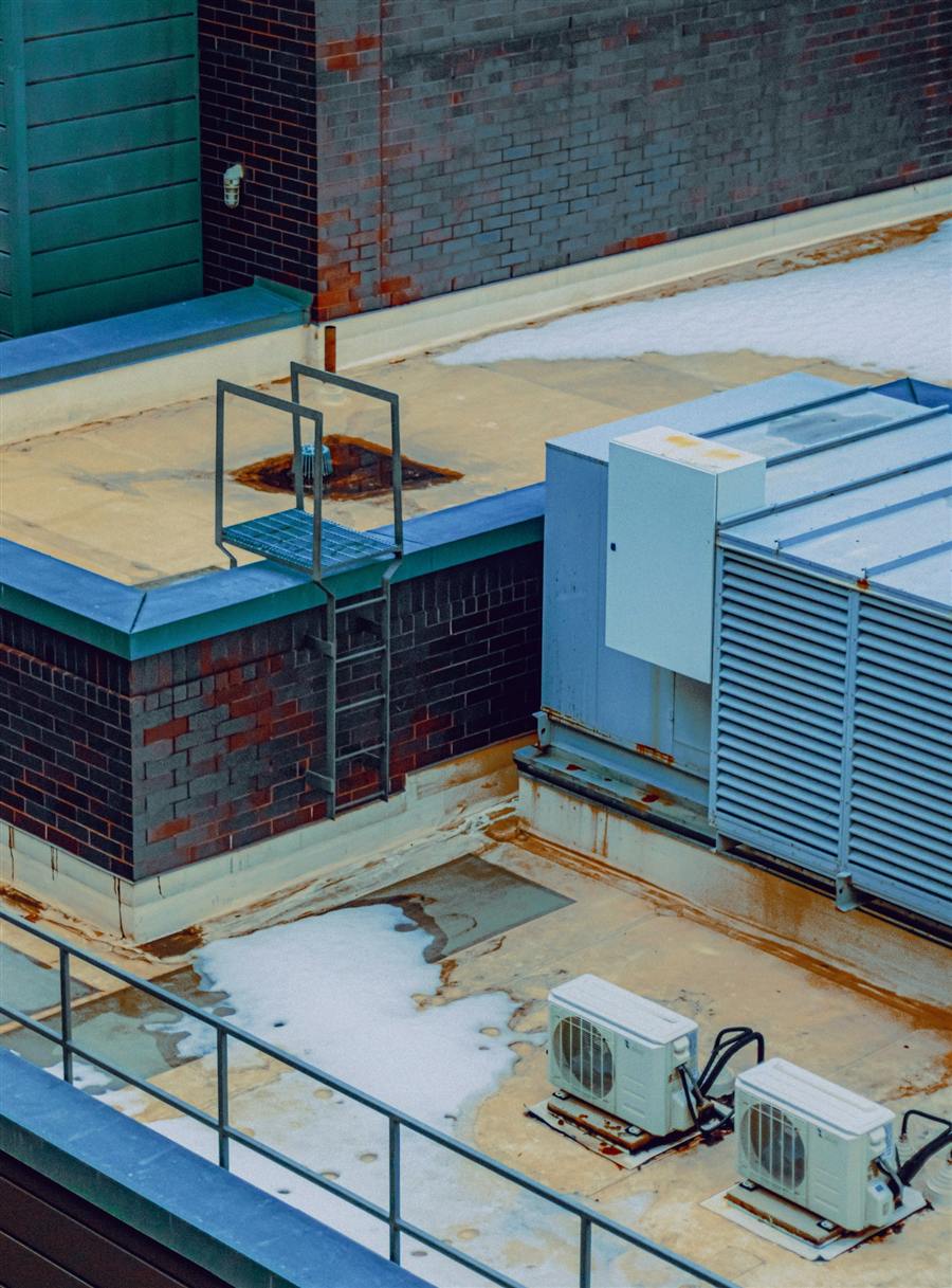 Commercial rooftop HVAC units in winter