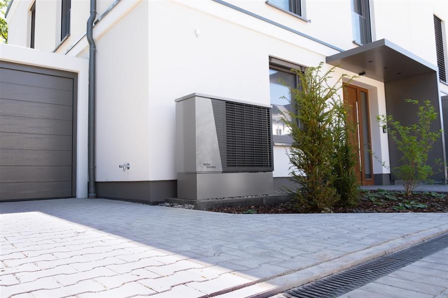 Residential heat pump installed beside a home